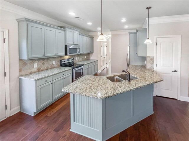 kitchen featuring sink, tasteful backsplash, kitchen peninsula, decorative light fixtures, and appliances with stainless steel finishes