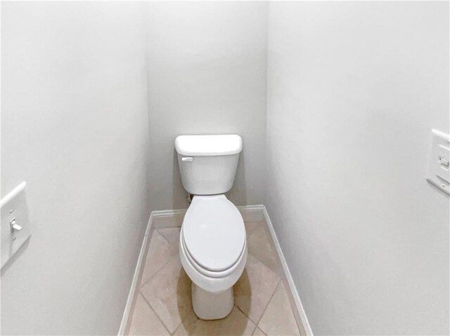 bathroom featuring tile patterned flooring and toilet