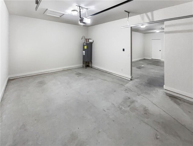 garage featuring a garage door opener and water heater