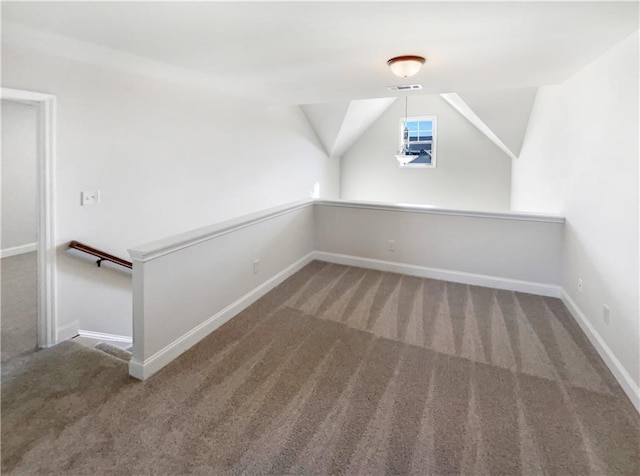 additional living space with carpet floors and lofted ceiling