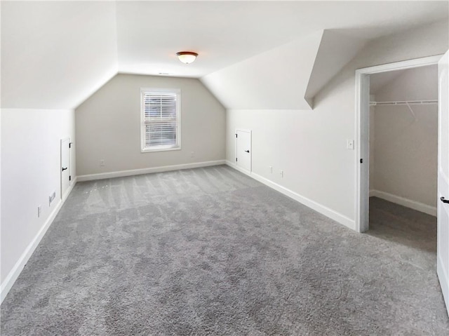 bonus room with carpet and vaulted ceiling