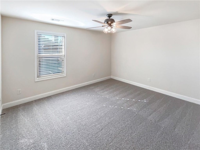 empty room featuring dark colored carpet and ceiling fan