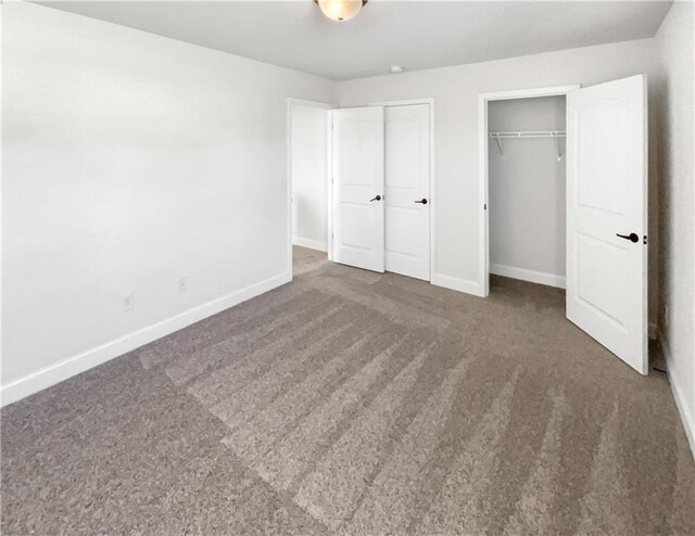 unfurnished bedroom with dark colored carpet