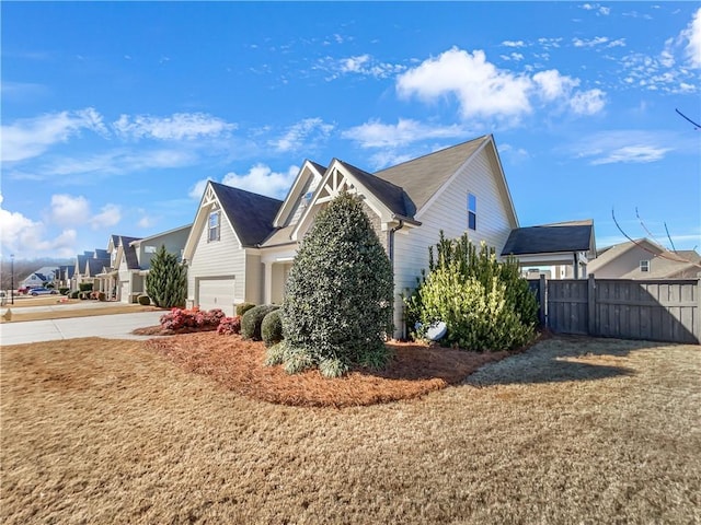 view of side of property featuring a yard and a garage