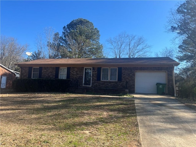 ranch-style home with a garage and a front lawn