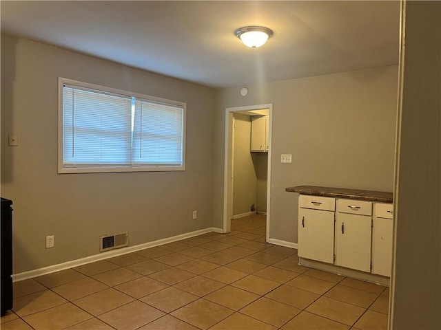 unfurnished room with light tile patterned floors