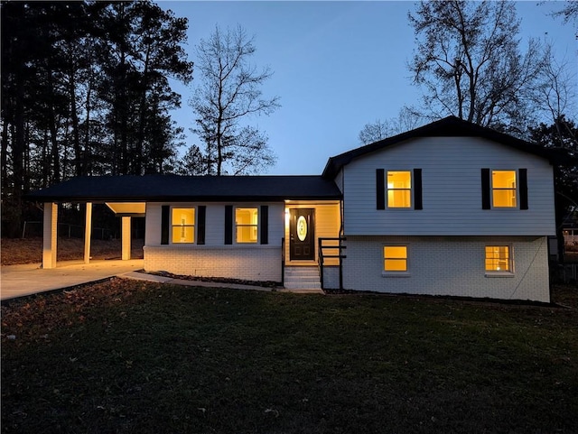 view of front facade with a carport and a lawn