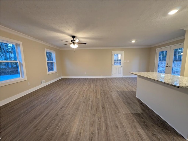 unfurnished living room with french doors, dark hardwood / wood-style flooring, a textured ceiling, and ornamental molding