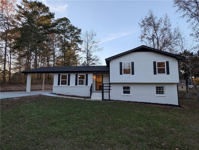 split level home featuring a front yard and a carport