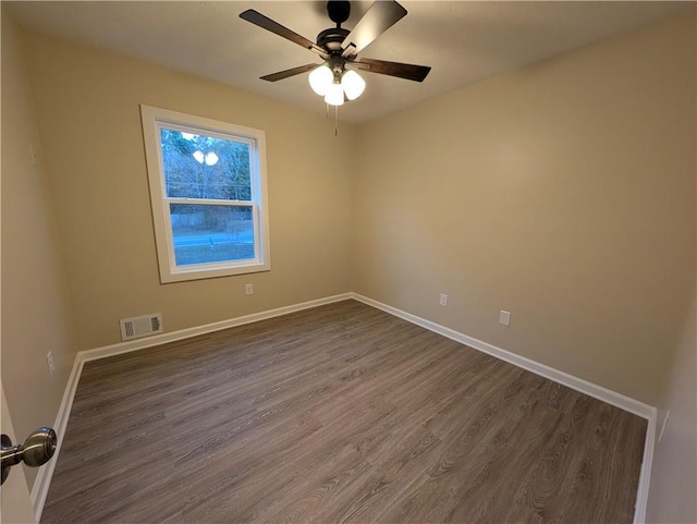 spare room with ceiling fan and dark hardwood / wood-style floors