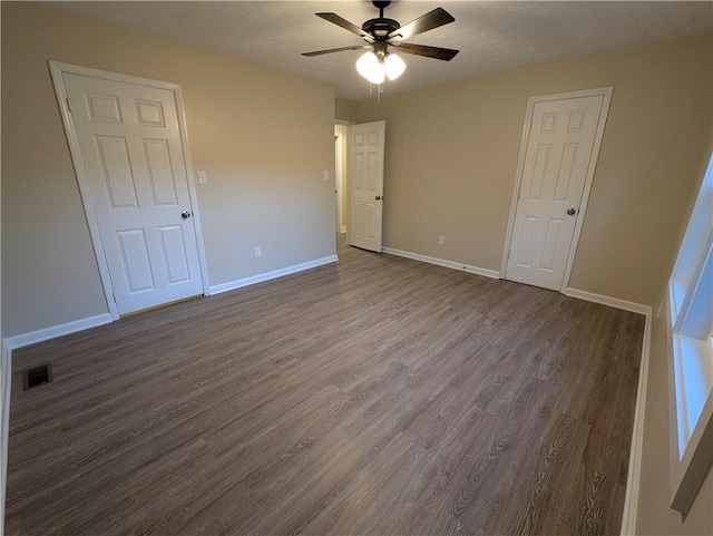 unfurnished bedroom featuring ceiling fan, wood-type flooring, and a textured ceiling