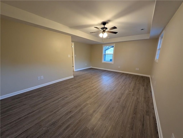 unfurnished room with ceiling fan and dark wood-type flooring