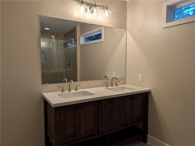 bathroom featuring vanity and a shower with shower door