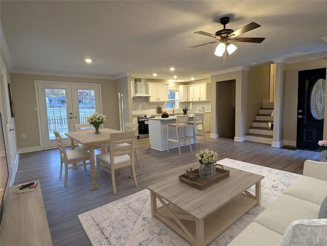 living room featuring french doors, dark hardwood / wood-style floors, ceiling fan, and crown molding