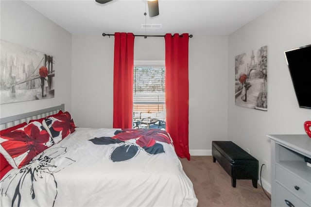 carpeted bedroom with baseboards, visible vents, and a ceiling fan