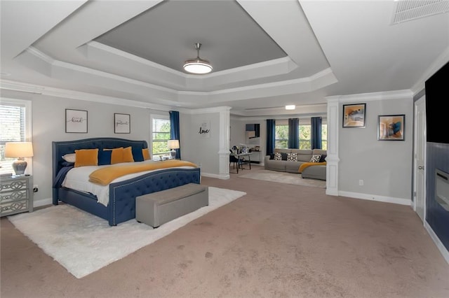 bedroom with multiple windows, visible vents, a raised ceiling, and carpet flooring