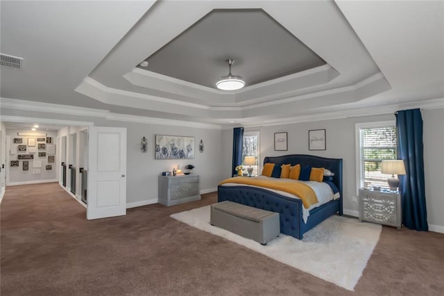 bedroom featuring carpet floors, visible vents, and a tray ceiling