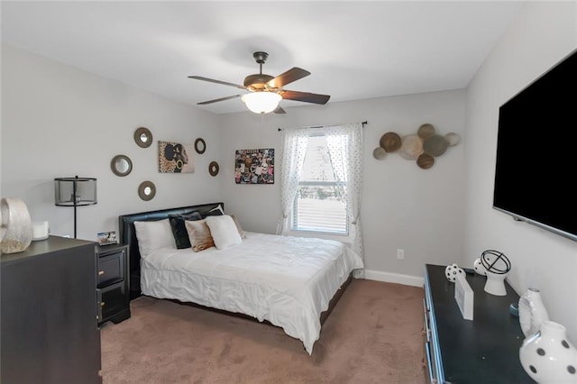 carpeted bedroom featuring a ceiling fan and baseboards