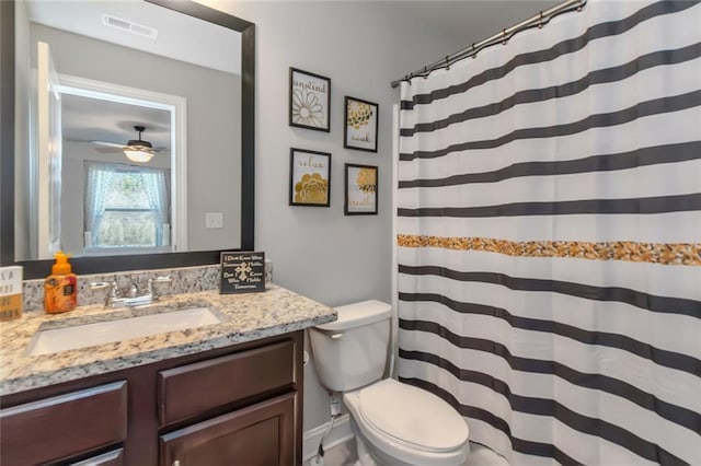 bathroom featuring toilet, visible vents, a shower with shower curtain, and vanity