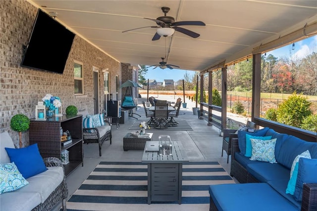 view of patio featuring outdoor dining area, ceiling fan, and an outdoor living space