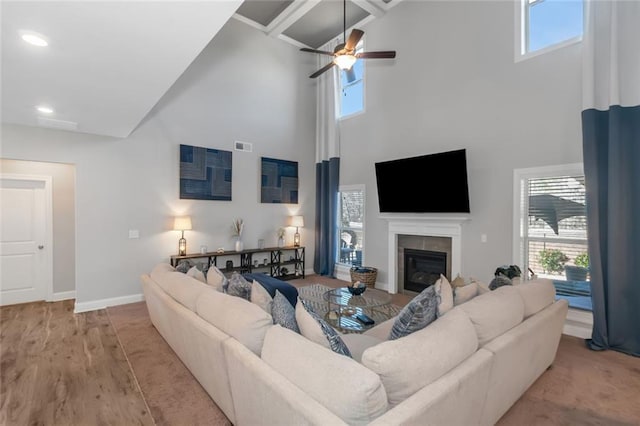 living area featuring visible vents, baseboards, wood finished floors, a fireplace, and recessed lighting