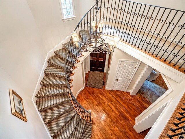 stairs featuring hardwood / wood-style floors