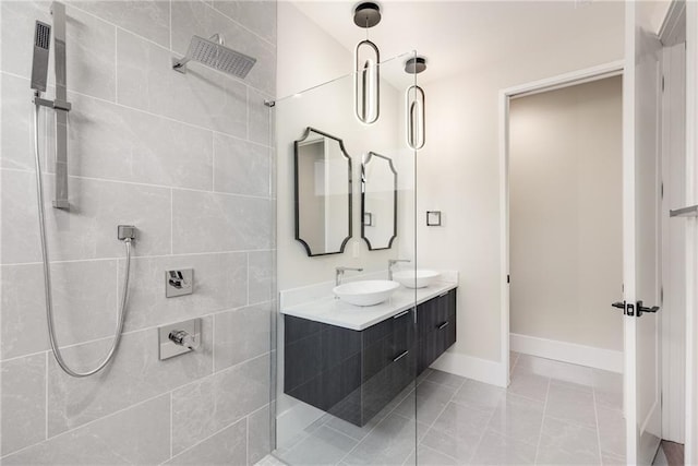 bathroom with a tile shower, tile patterned floors, and vanity