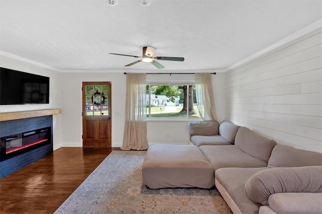 1162 Newtown Church Rd NE, Calhoun, GA 30701 - living room featuring wood finished floors, a ceiling fan, a glass covered fireplace, ornamental molding, and a textured ceiling