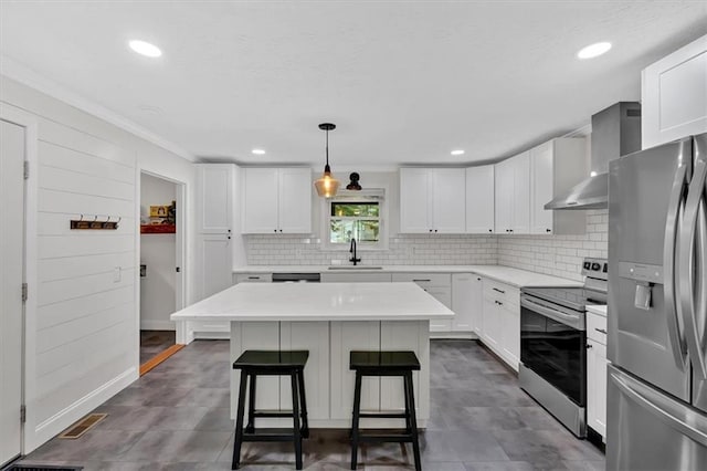 1162 Newtown Church Rd NE, Calhoun, GA 30701 - kitchen with stainless steel appliances, wall chimney exhaust hood, a kitchen breakfast bar, backsplash, and crown molding