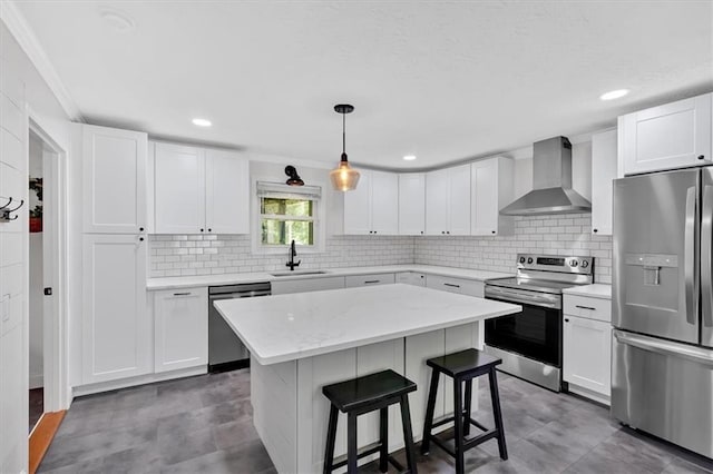1162 Newtown Church Rd NE, Calhoun, GA 30701 - kitchen featuring appliances with stainless steel finishes, wall chimney exhaust hood, a breakfast bar, a kitchen island, and white cabinetry