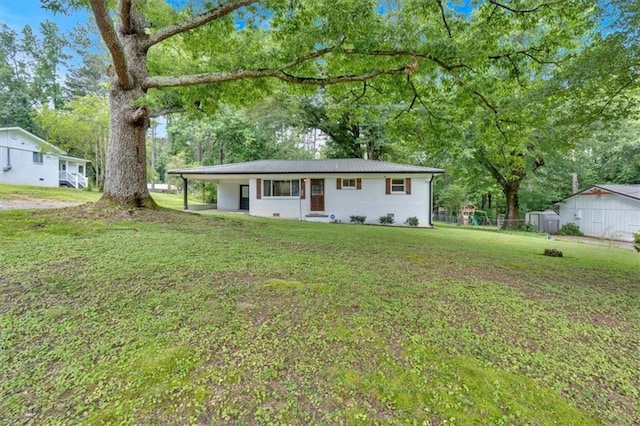 1162 Newtown Church Rd NE, Calhoun, GA 30701 - ranch-style house with a front yard, a metal roof, a carport, and view of wooded area