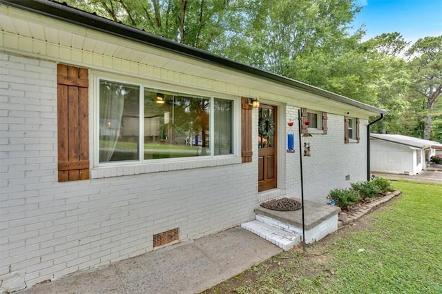 1162 Newtown Church Rd NE, Calhoun, GA 30701 - view of exterior entry featuring brick siding, crawl space, and a lawn