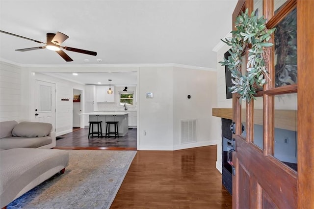 1162 Newtown Church Rd NE, Calhoun, GA 30701 - living area with crown molding, dark wood finished floors, a ceiling fan, a fireplace, and recessed lighting
