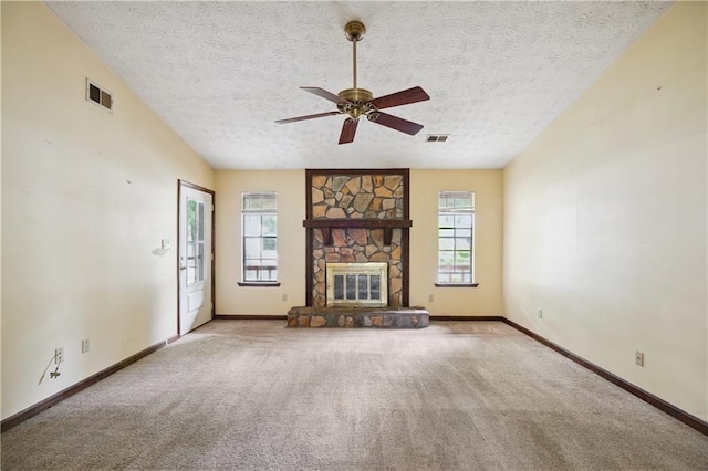 unfurnished living room with ceiling fan, light colored carpet, a fireplace, a textured ceiling, and lofted ceiling