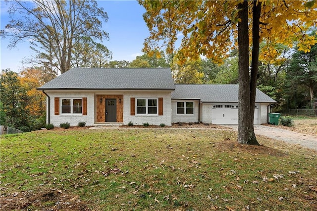 single story home with a front yard and a garage