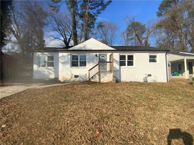 view of front facade with a carport and a front lawn