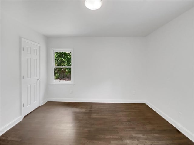 empty room featuring dark hardwood / wood-style flooring