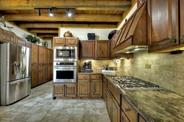 115 Coldwater Creek Dr, Mineral Bluff, GA 30559 - kitchen featuring stainless steel appliances, track lighting, a wooden ceiling with exposed beams, dark stone countertops, and custom range hood