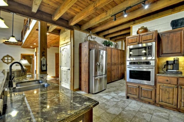 115 Coldwater Creek Dr, Mineral Bluff, GA 30559 - kitchen featuring appliances with stainless steel finishes, a wood ceiling with exposed beams, track lighting, wood walls, and dark stone counters