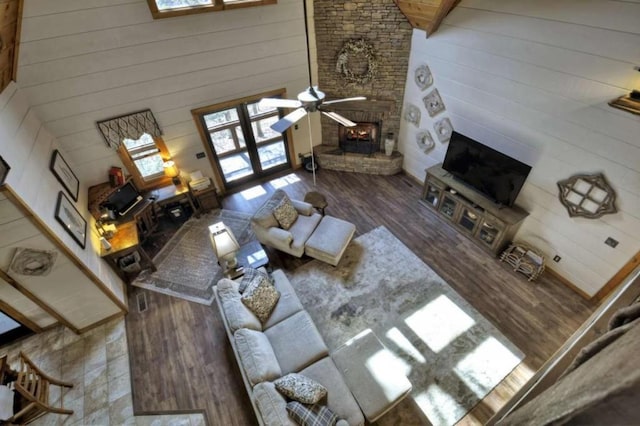 115 Coldwater Creek Dr, Mineral Bluff, GA 30559 - living room featuring wooden walls, a fireplace, wood finished floors, a ceiling fan, and high vaulted ceiling