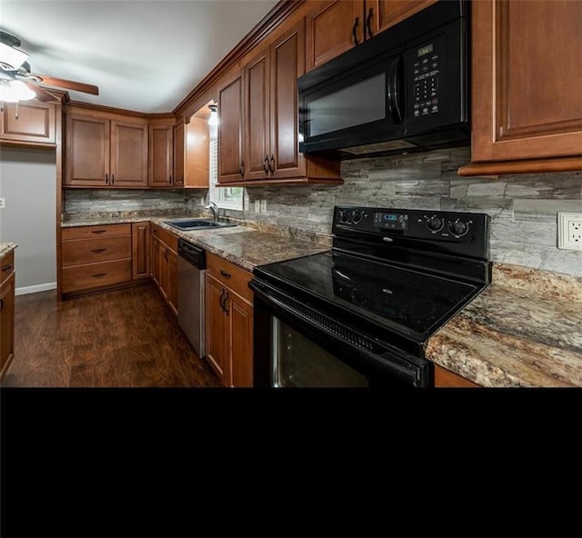 kitchen with ceiling fan, sink, light stone counters, dark hardwood / wood-style floors, and black appliances