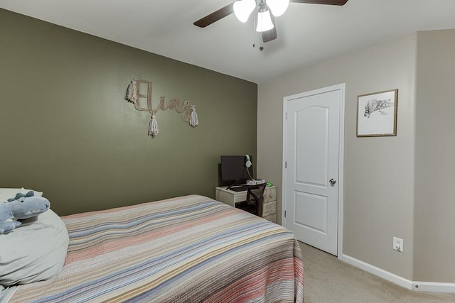 bedroom with baseboards, ceiling fan, and light colored carpet