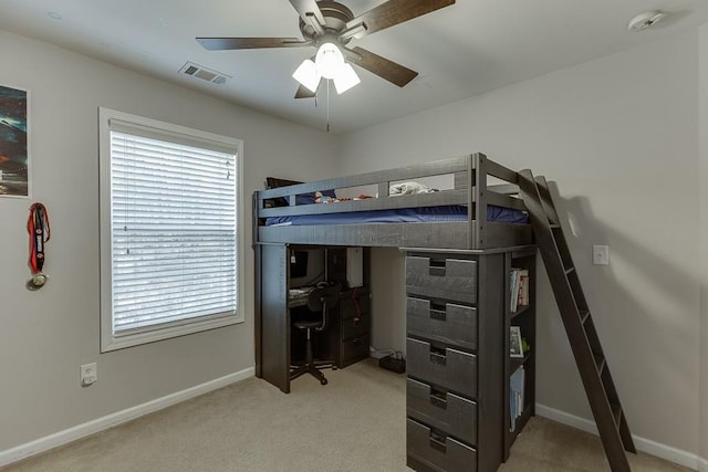 carpeted bedroom with visible vents, ceiling fan, and baseboards