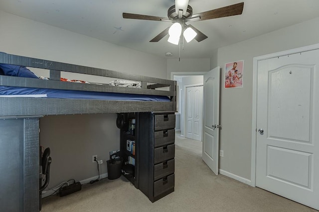 bedroom featuring light carpet, ceiling fan, and baseboards