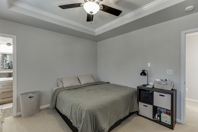 bedroom featuring baseboards, a raised ceiling, light colored carpet, ceiling fan, and ornamental molding