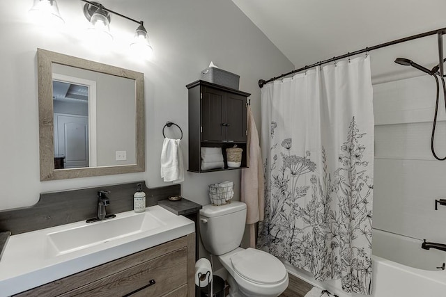 bathroom featuring toilet, shower / bath combo with shower curtain, and vanity