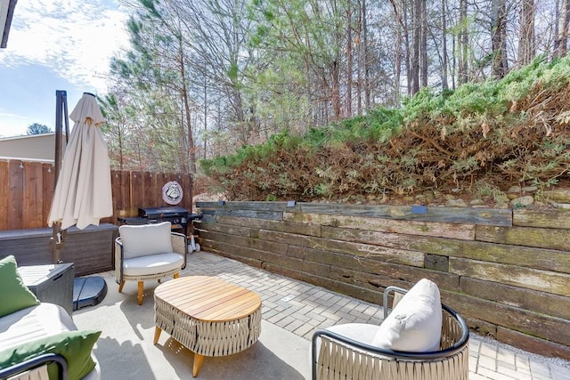 view of patio / terrace with a grill and fence