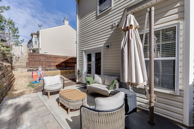 view of patio / terrace featuring an outdoor hangout area and fence