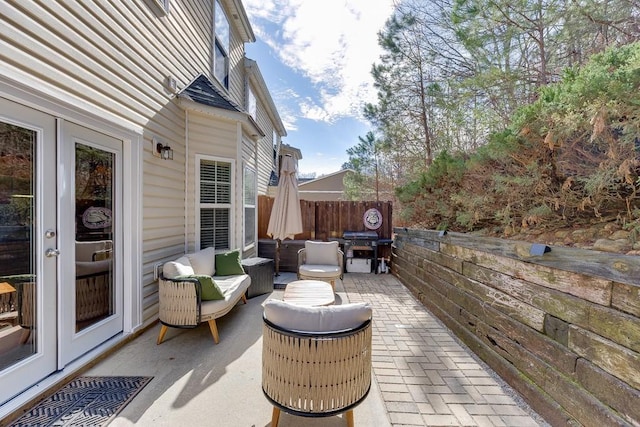 view of patio / terrace featuring fence, an outdoor living space, and area for grilling