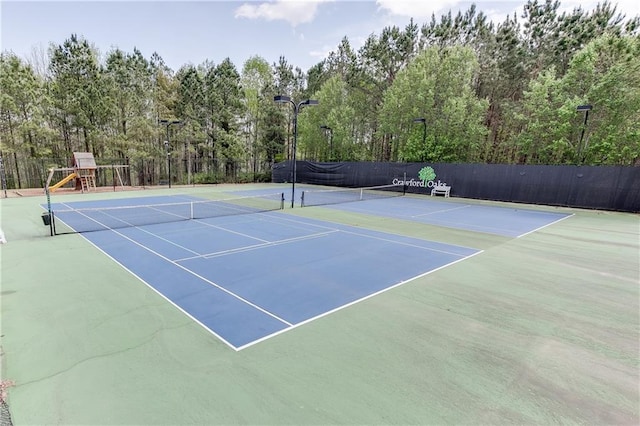 view of sport court with playground community and fence